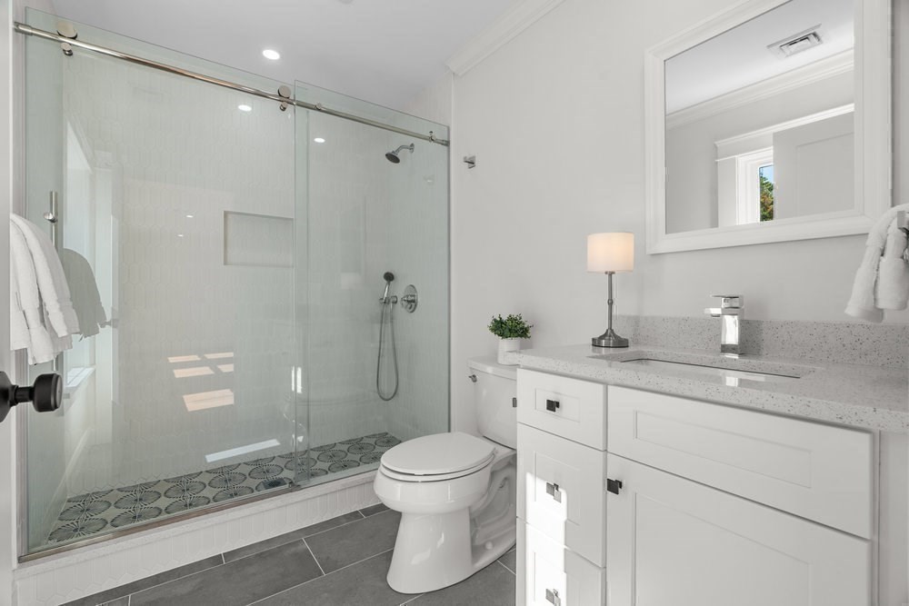 22 Tyler Road Lexington, MA 02420 - Photo 28 of 37 a bathroom with a sink a toilet and shower