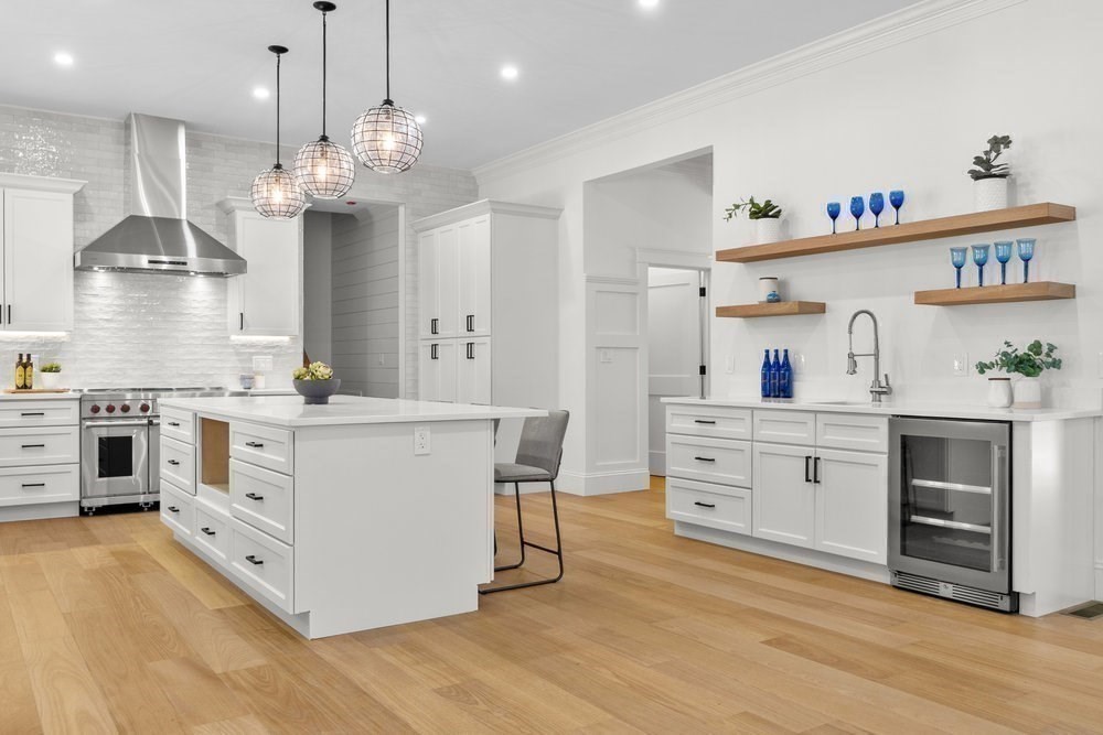 22 Tyler Road Lexington, MA 02420 - Photo 7 of 37 a kitchen with kitchen island white cabinets and stainless steel appliances