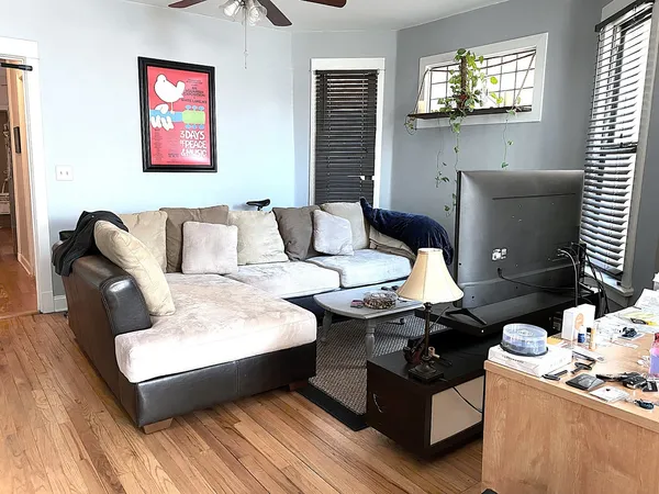 a living room with furniture and wooden floor