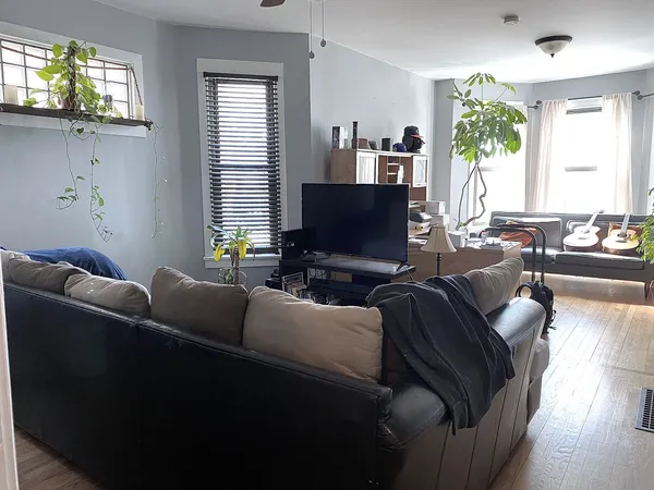 a living room with furniture and a flat screen tv