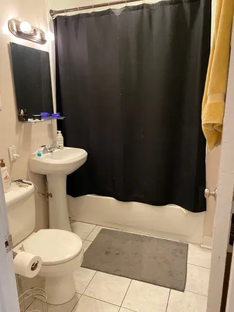 a bathroom with a sink toilet and mirror