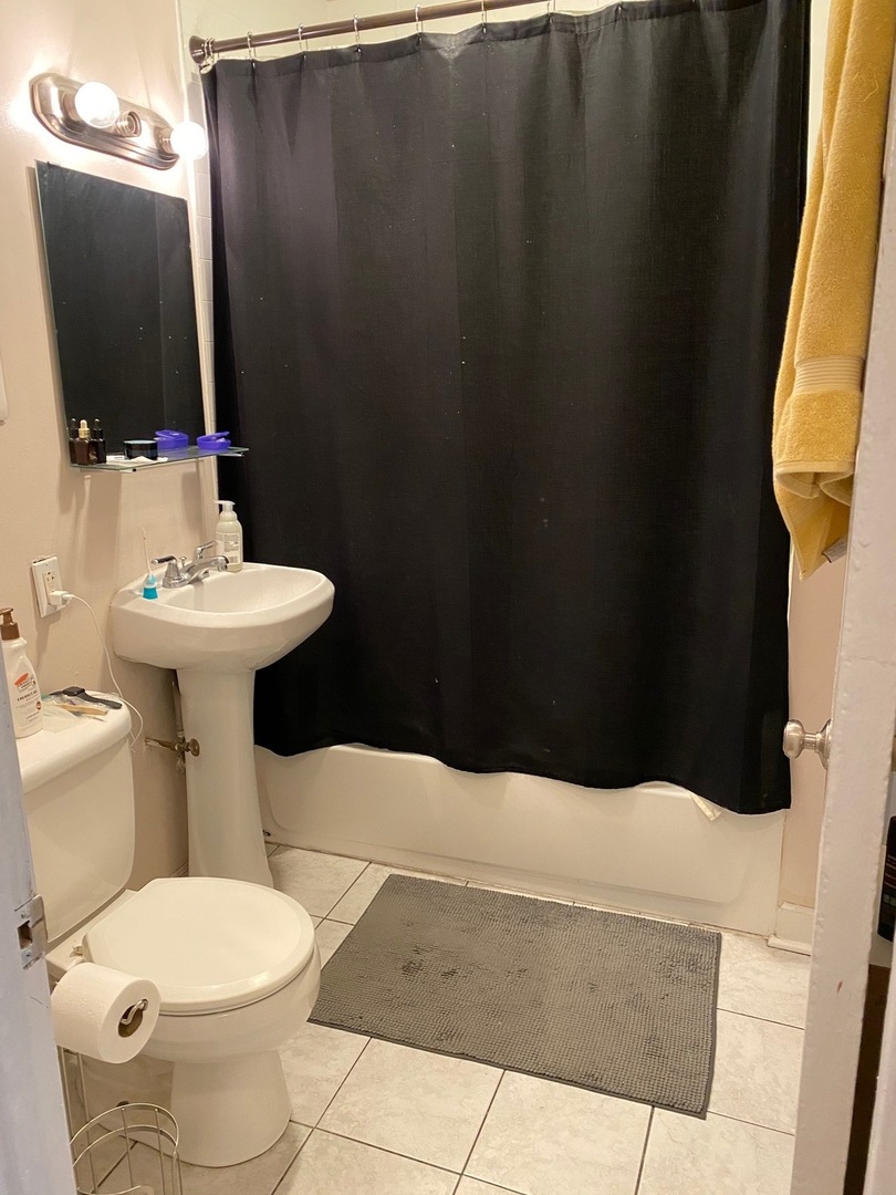 3926 West Byron Street, Unit 1 Chicago, IL 60618 - Photo 7 of 9 a bathroom with a sink toilet and mirror