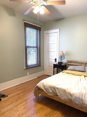 a spacious bedroom with a bed and a window