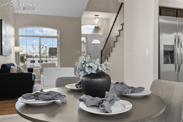 5428 Rondo Way Colorado Springs, CO 80911 - Photo 10 of 43 Dining space with stairs and wood finished floors