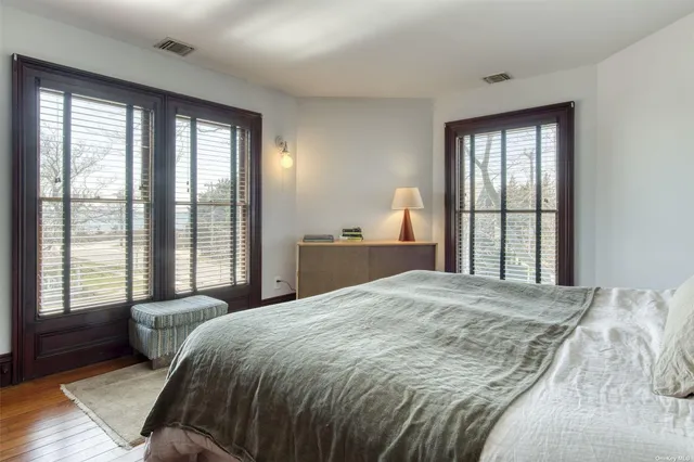 a bedroom with a large bed and a large window