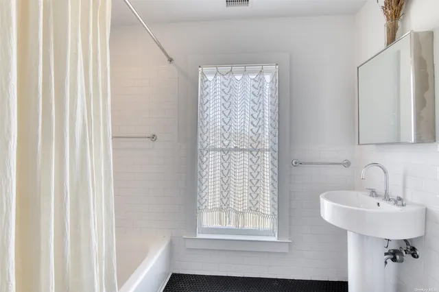 a bathroom with a sink a mirror and a shower