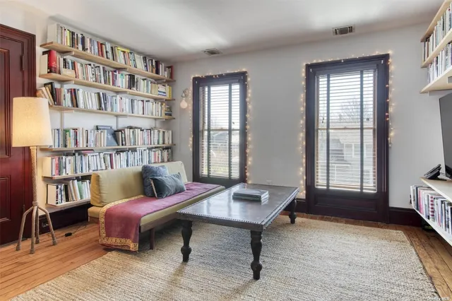 a living room with furniture and a book shelf