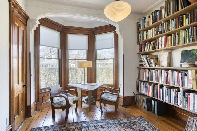 a view of a livingroom with furniture and a book shelf