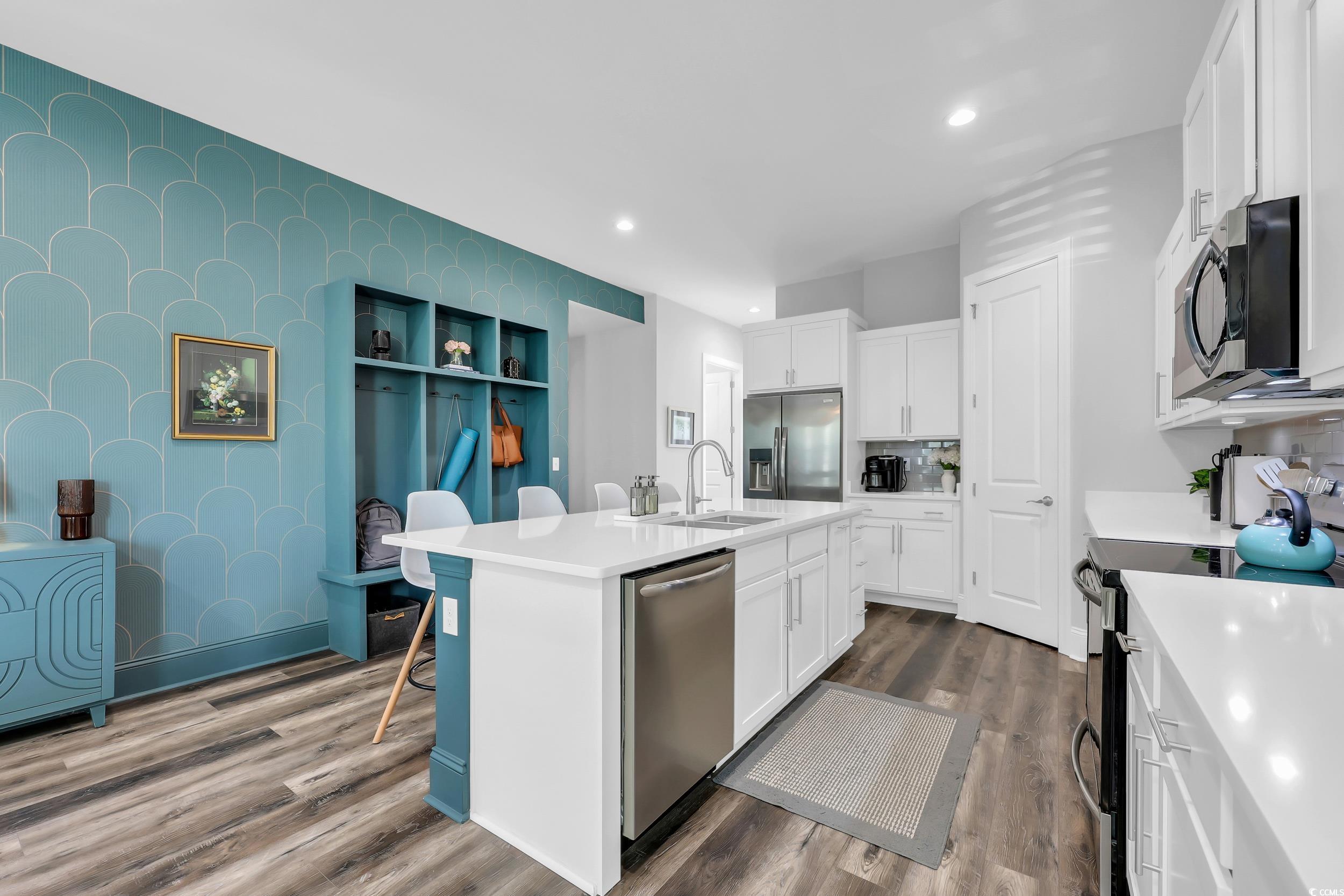 1307 Wading Heron Road North Myrtle Beach, SC 29582 - Photo 12 of 40 Kitchen with stainless steel appliances, dark wood finished floors, light countertops, white cabinetry, and recessed lighting