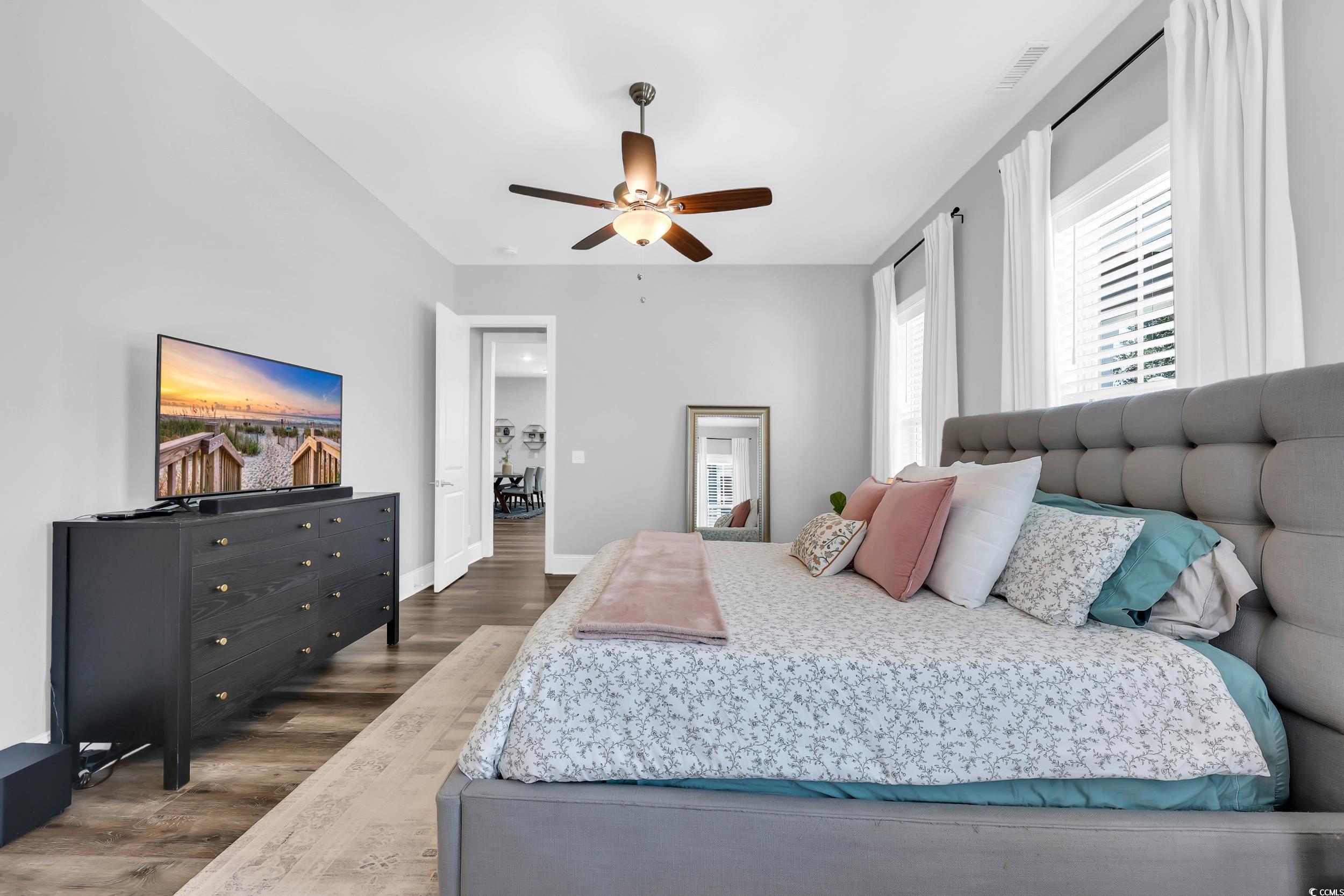1307 Wading Heron Road North Myrtle Beach, SC 29582 - Photo 19 of 40 Bedroom with dark wood-style flooring and a ceiling fan