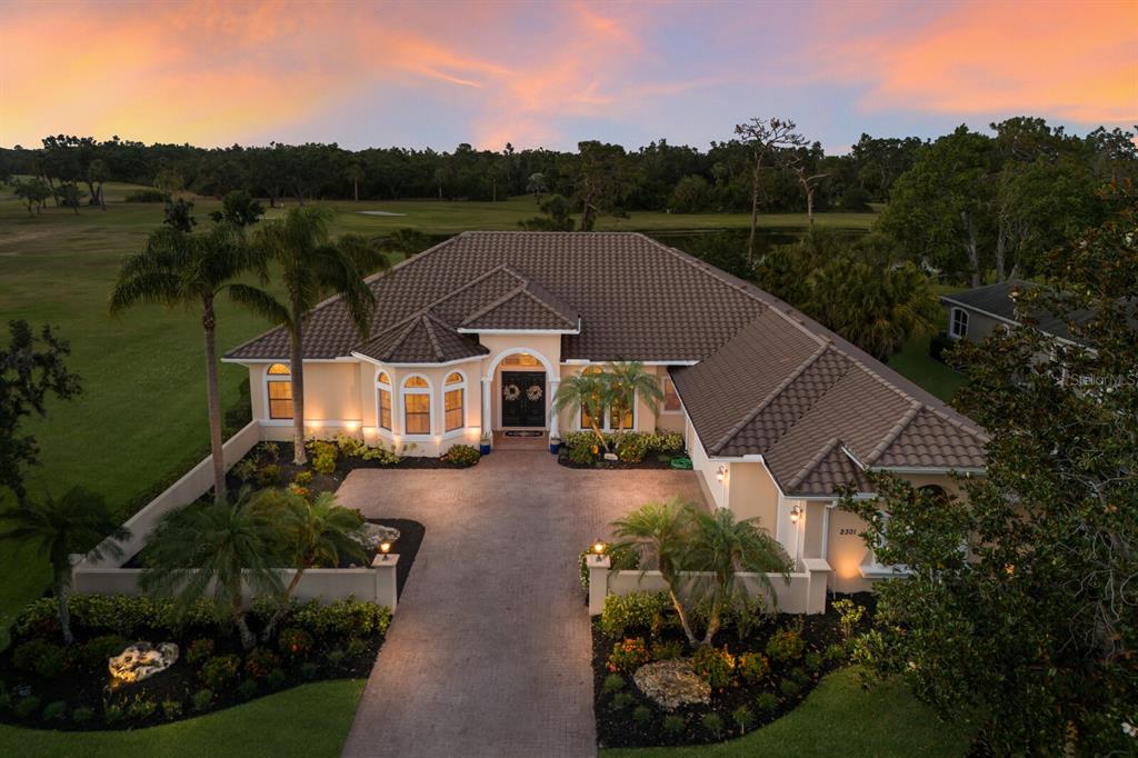 a view of a house with pool and a garden