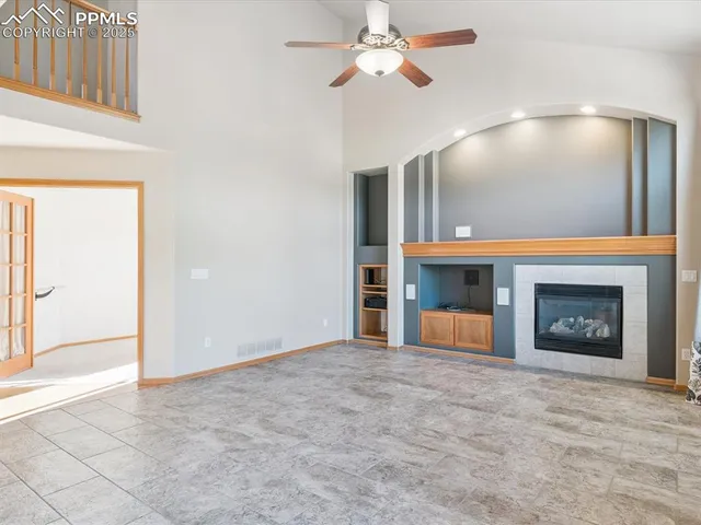 a kitchen with stainless steel appliances granite countertop dining table chairs stove refrigerator and cabinets