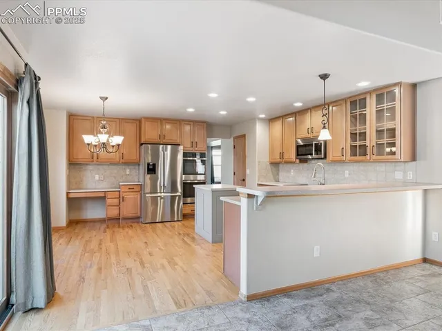 a view of an empty room with a fireplace and a window