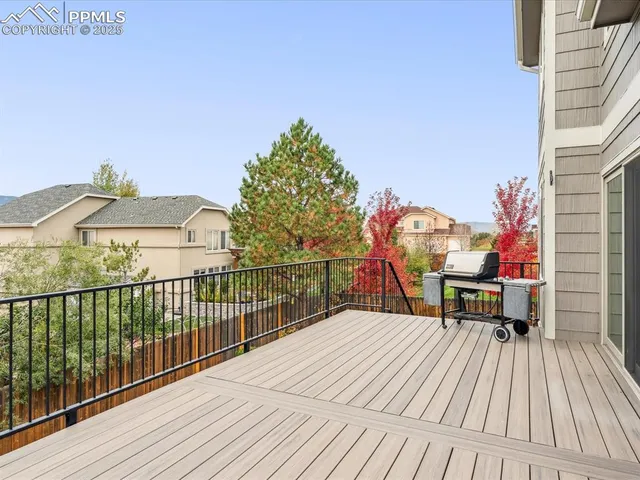 a view of balcony with wooden floor and fence