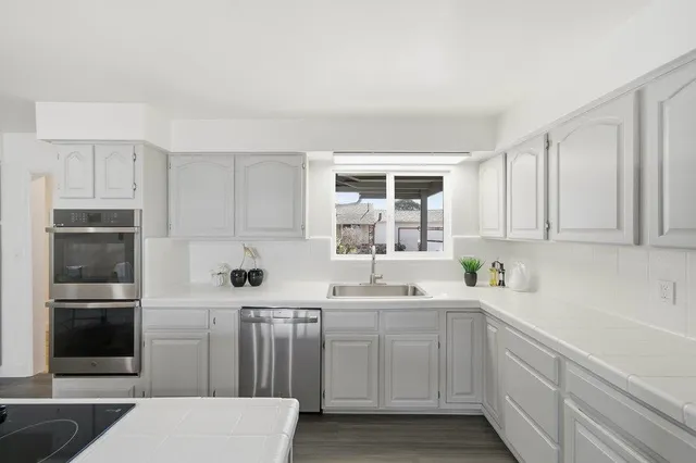 a kitchen with cabinets and window