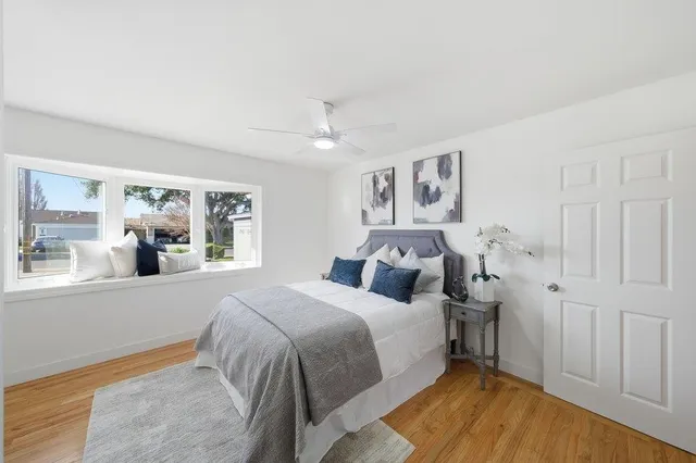 a bedroom with a large bed and a window