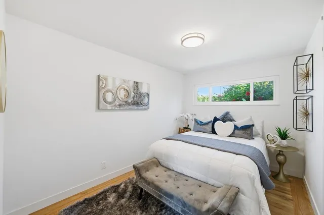 a bedroom with a bed and a wall painting