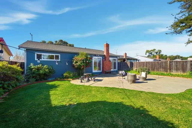 a view of a house with backyard porch and sitting area