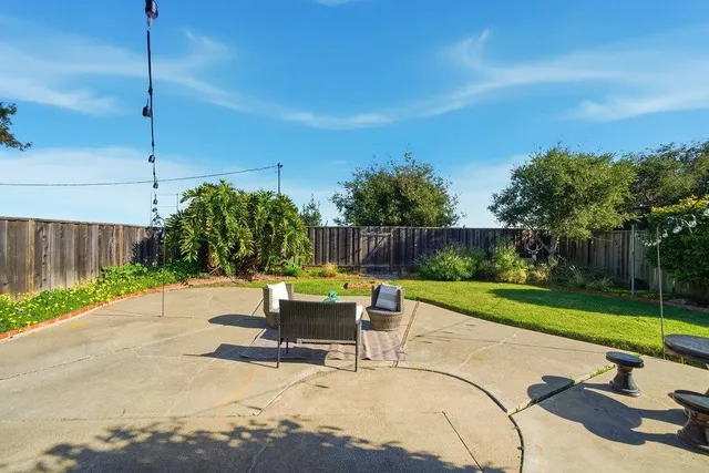 a view of a backyard with sitting area