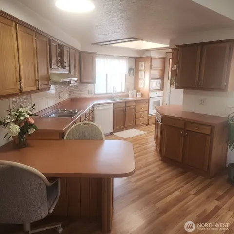 a kitchen with a sink cabinets and a window