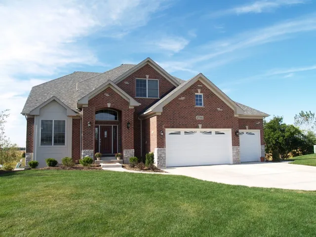 a front view of a house with a yard and garage