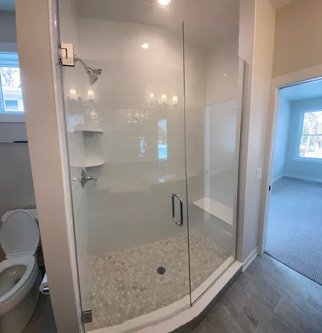 a bathroom with a glass shower door