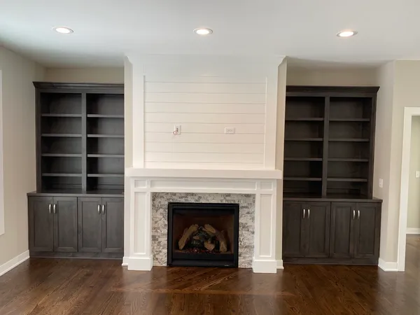 a living room with a fireplace and a wooden floor
