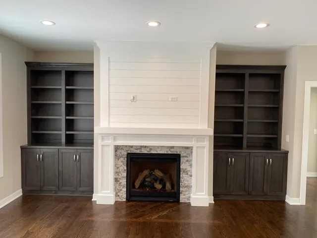 a living room with a fireplace and a wooden floor