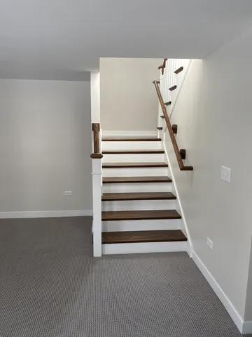 a view of a room with stairs and a hallway