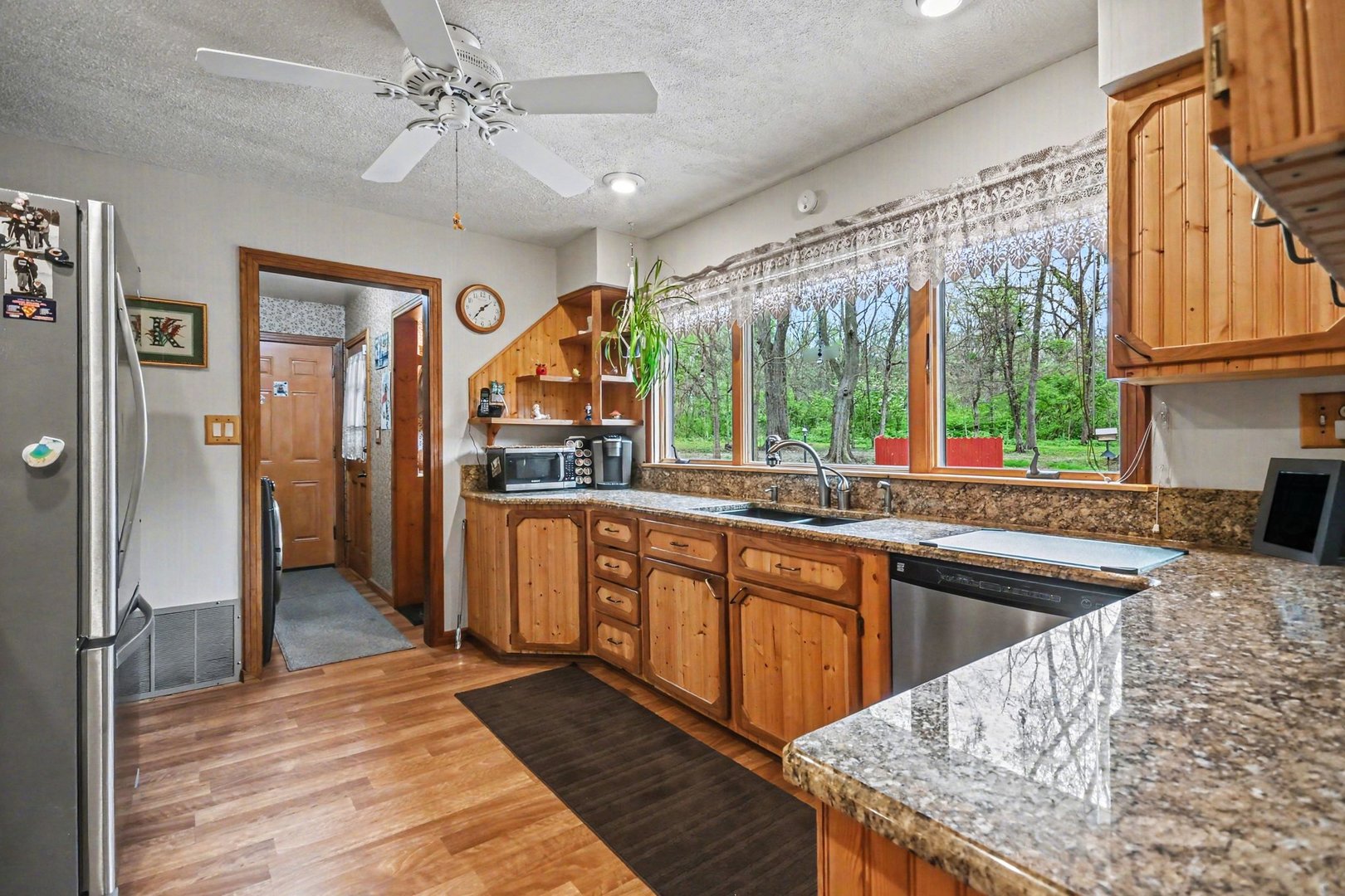 14340 West Bruce Road Homer Glen, IL 60491 - Photo 12 of 38 a kitchen with stainless steel appliances granite countertop a sink and wooden cabinets