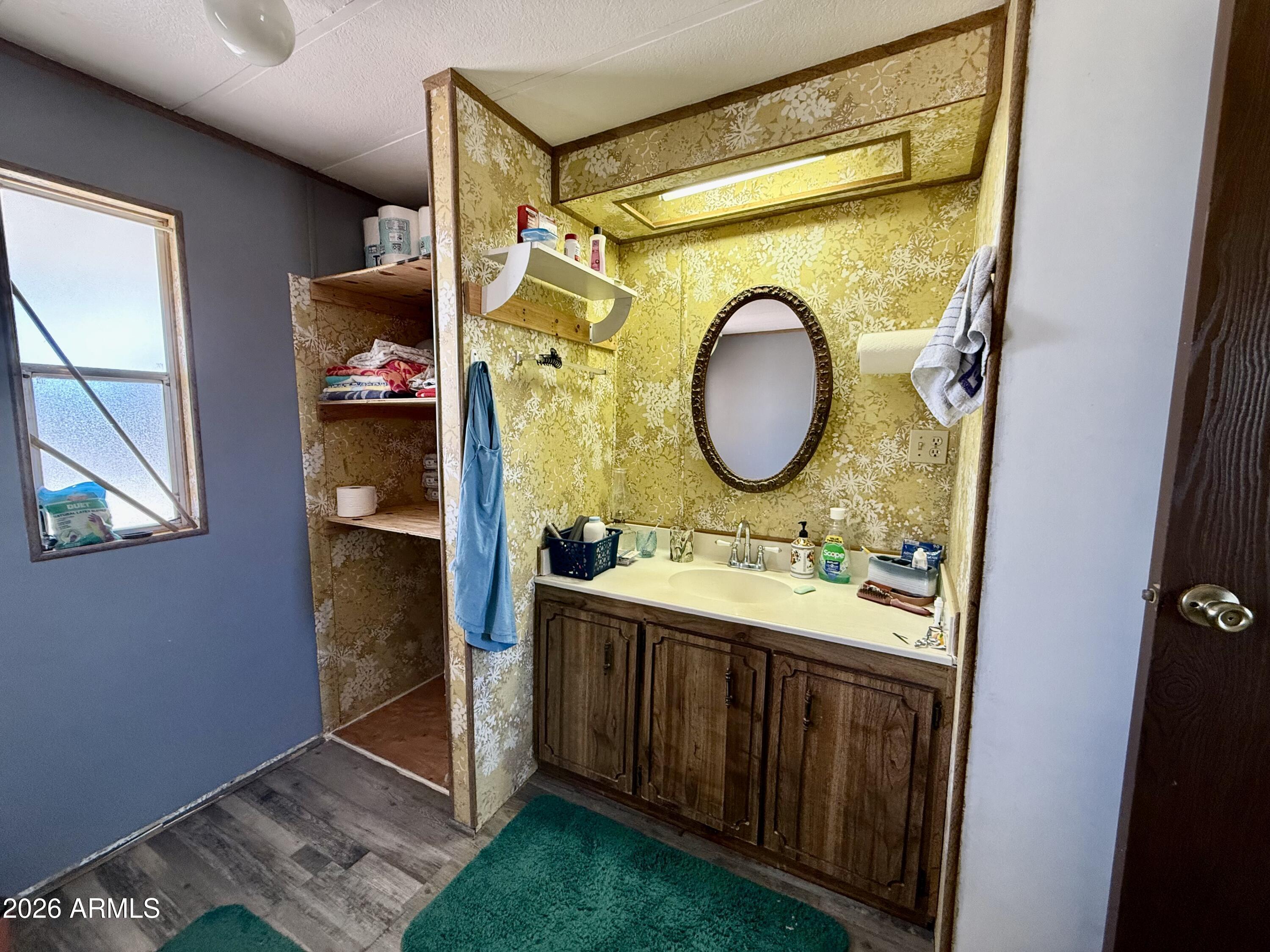 300 Airport Road, Unit 34 Kearny, AZ 85137 - Photo 7 of 18 a bathroom with a sink vanity and a mirror