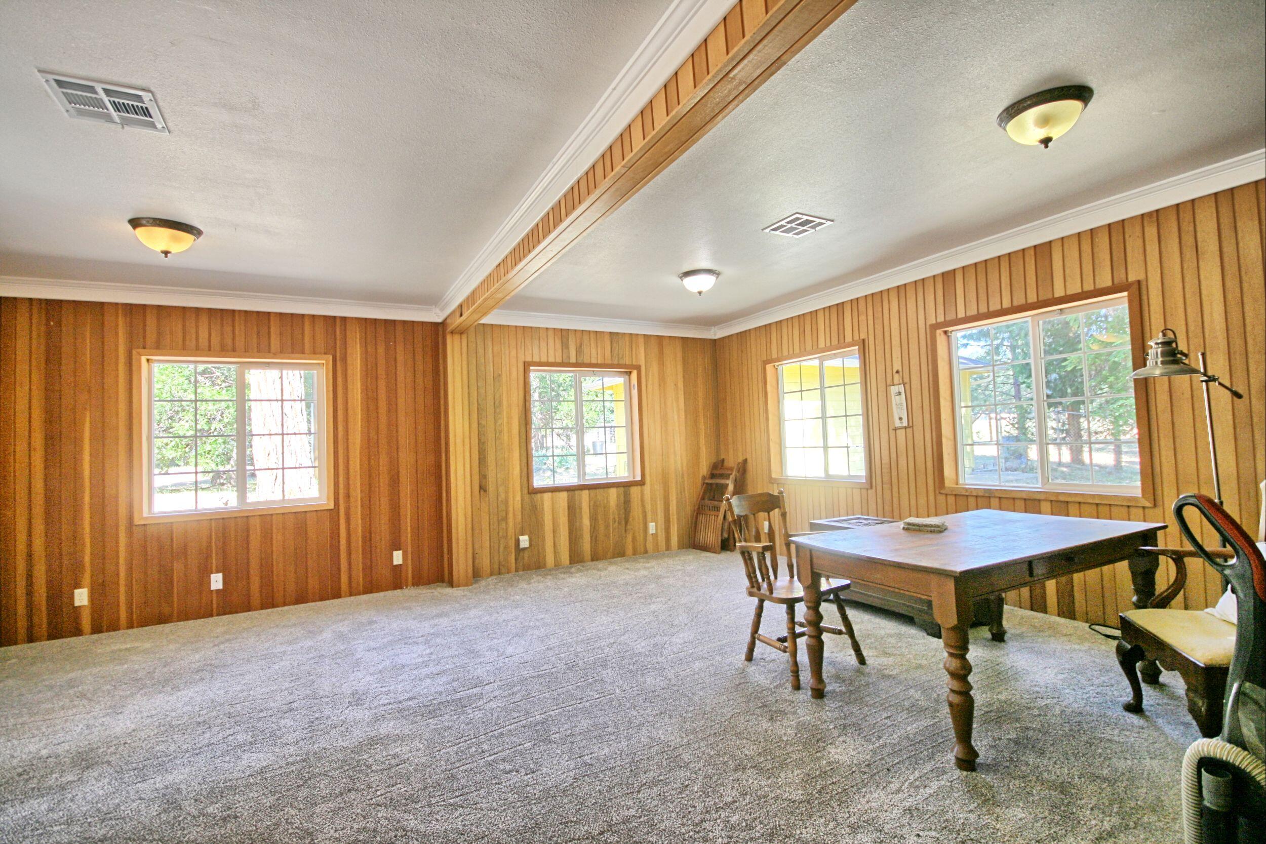 199 Powell Creek Road Williams, OR 97544 - Photo 25 of 57 a living room with furniture and a window