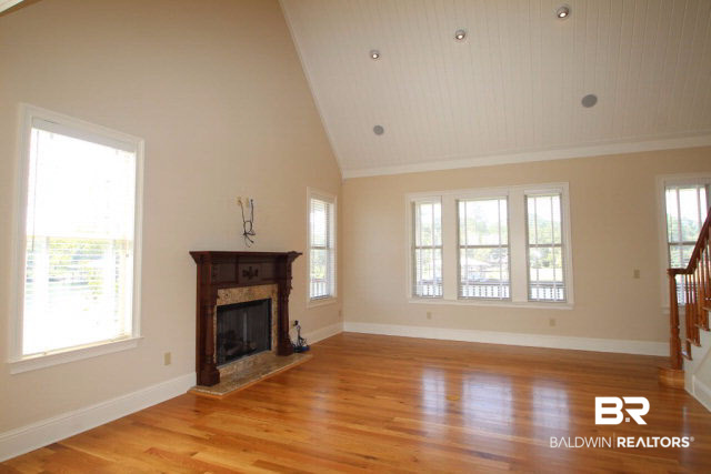 12900 Honey Rd Extension Summerdale, AL 36580 - Photo 25 of 44 Beautiful Vaulted tongue and groove ceilings in this gorgeous great room. Panoramic views of the river and fabulous fireplace with custom mantle! There are also interior and exterior LED lighting!