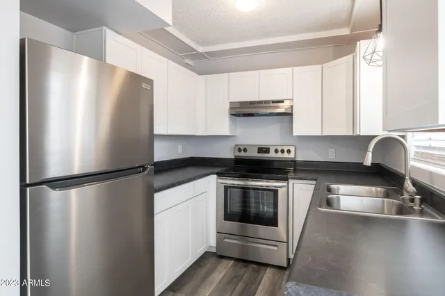 a kitchen with a refrigerator and a sink
