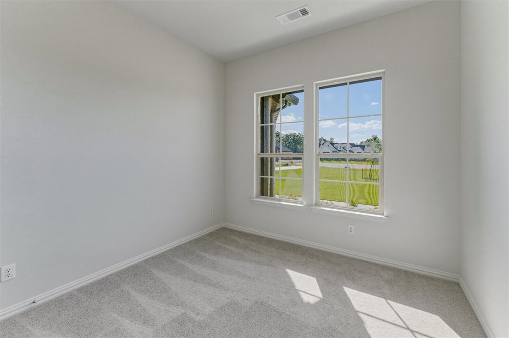 605 Tay Tay Way Springtown, TX 76082 - Photo 11 of 31 Neutral-toned room featuring a pair of double-hung windows with grid panes, light gray carpet, white baseboards, and a ceiling vent