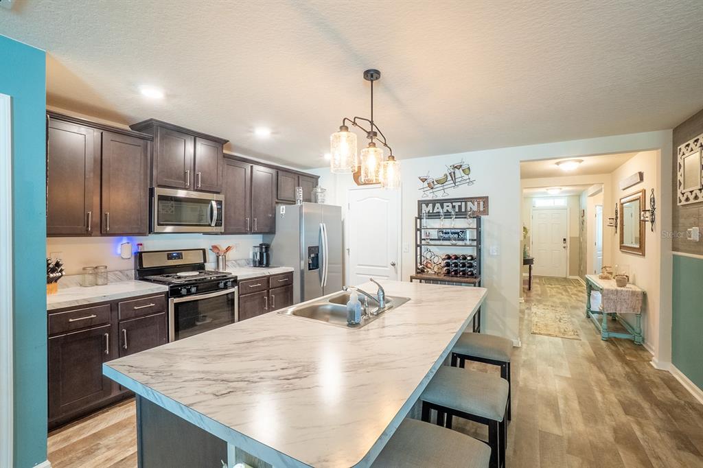 15 Grand Par Court Bunnell, FL 32110 - Photo 17 of 61 a kitchen with stainless steel appliances granite countertop a sink stove and refrigerator