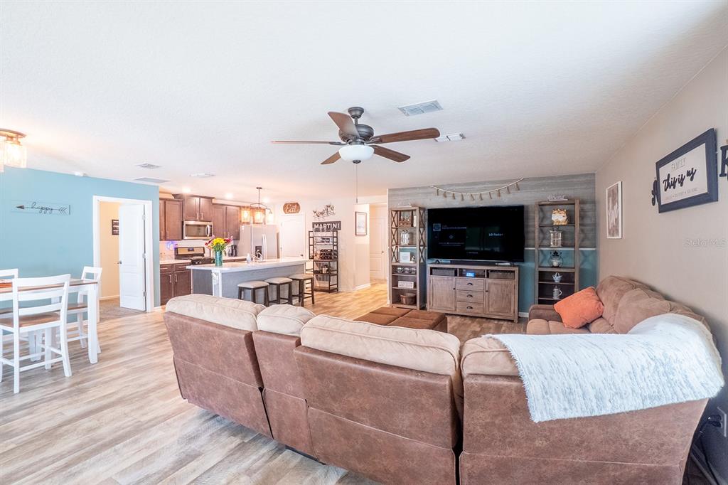 15 Grand Par Court Bunnell, FL 32110 - Photo 23 of 61 a living room with furniture and a flat screen tv