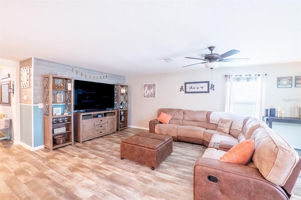 15 Grand Par Court Bunnell, FL 32110 - Photo 24 of 61 a living room with furniture and a flat screen tv