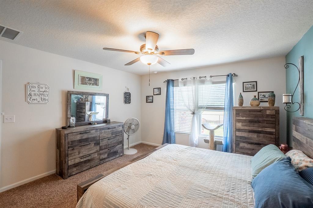 15 Grand Par Court Bunnell, FL 32110 - Photo 27 of 61 a bedroom with a bed and dresser