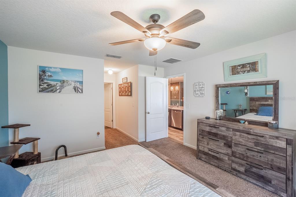 15 Grand Par Court Bunnell, FL 32110 - Photo 40 of 61 a bedroom with a bed and a dresser in it