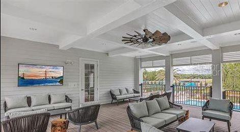 15 Grand Par Court Bunnell, FL 32110 - Photo 59 of 61 a living room with furniture a flat screen tv and a large window