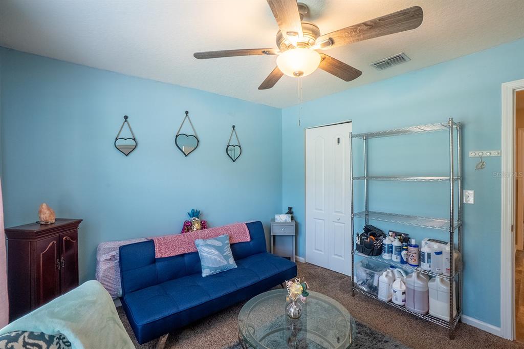 15 Grand Par Court Bunnell, FL 32110 - Photo 7 of 61 a living room with furniture and a chandelier