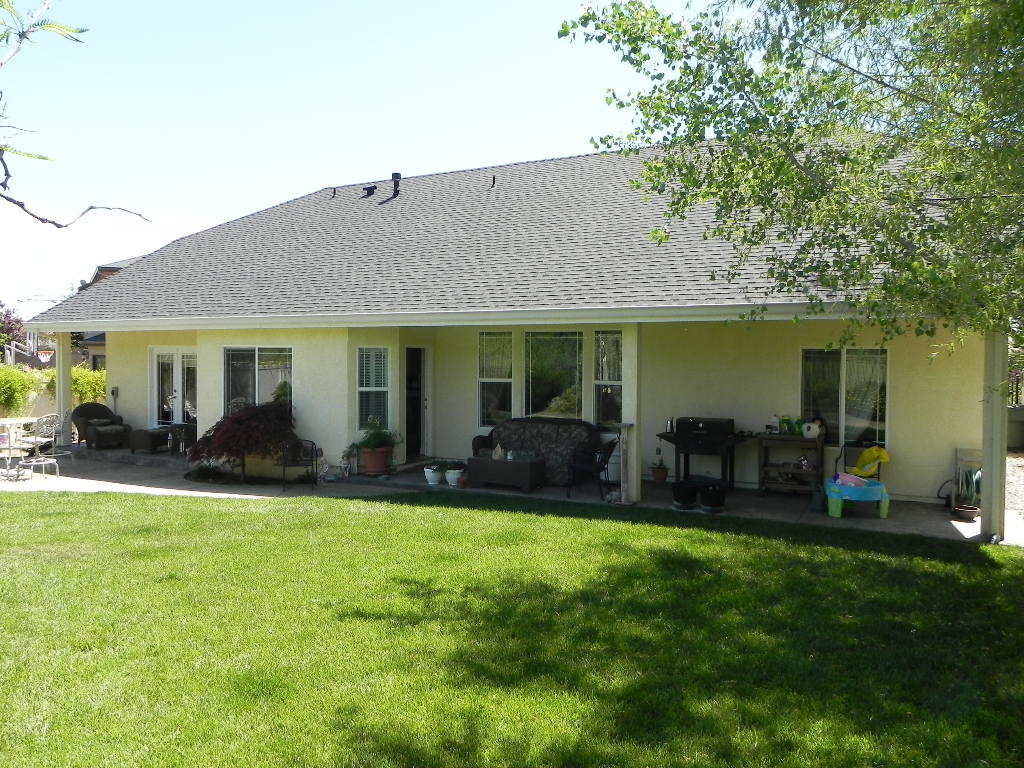 951 River Bend Road Redding, CA 96003 - Photo 17 of 21 BACK OF HOME WITH COVERED PATIO