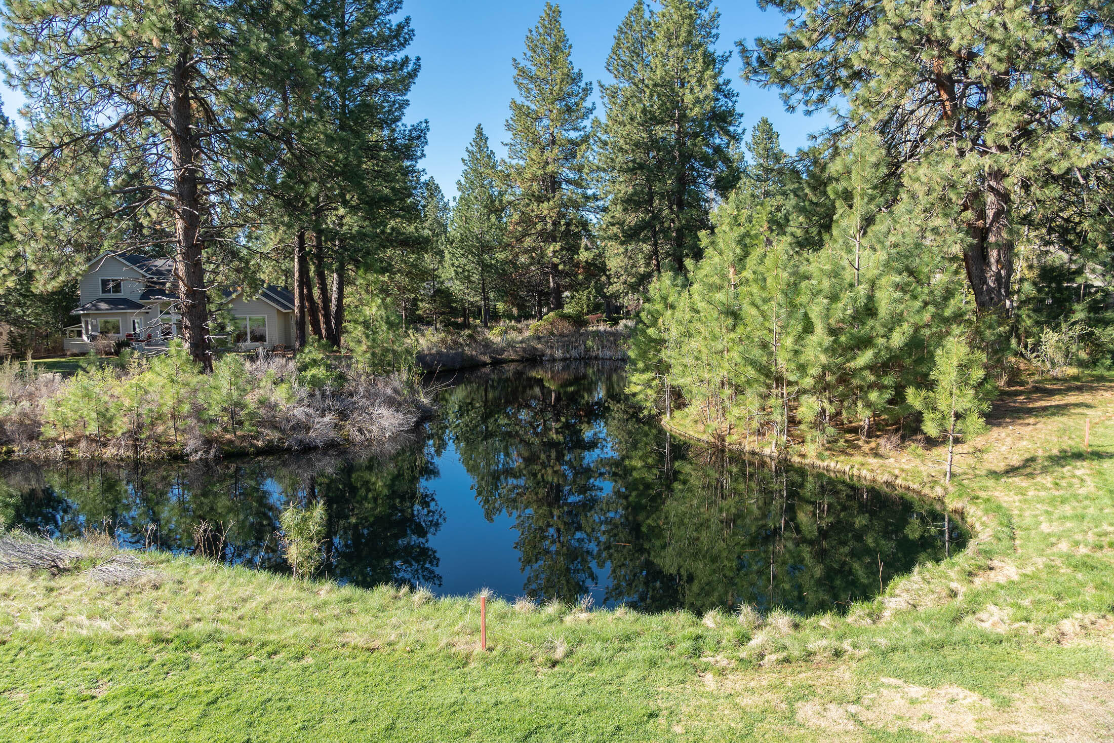 60711 Golf Village Loop Bend, OR 97702 - Photo 19 of 31 From edge of pond on 6th hole, showing the rear edge of the lot rear left