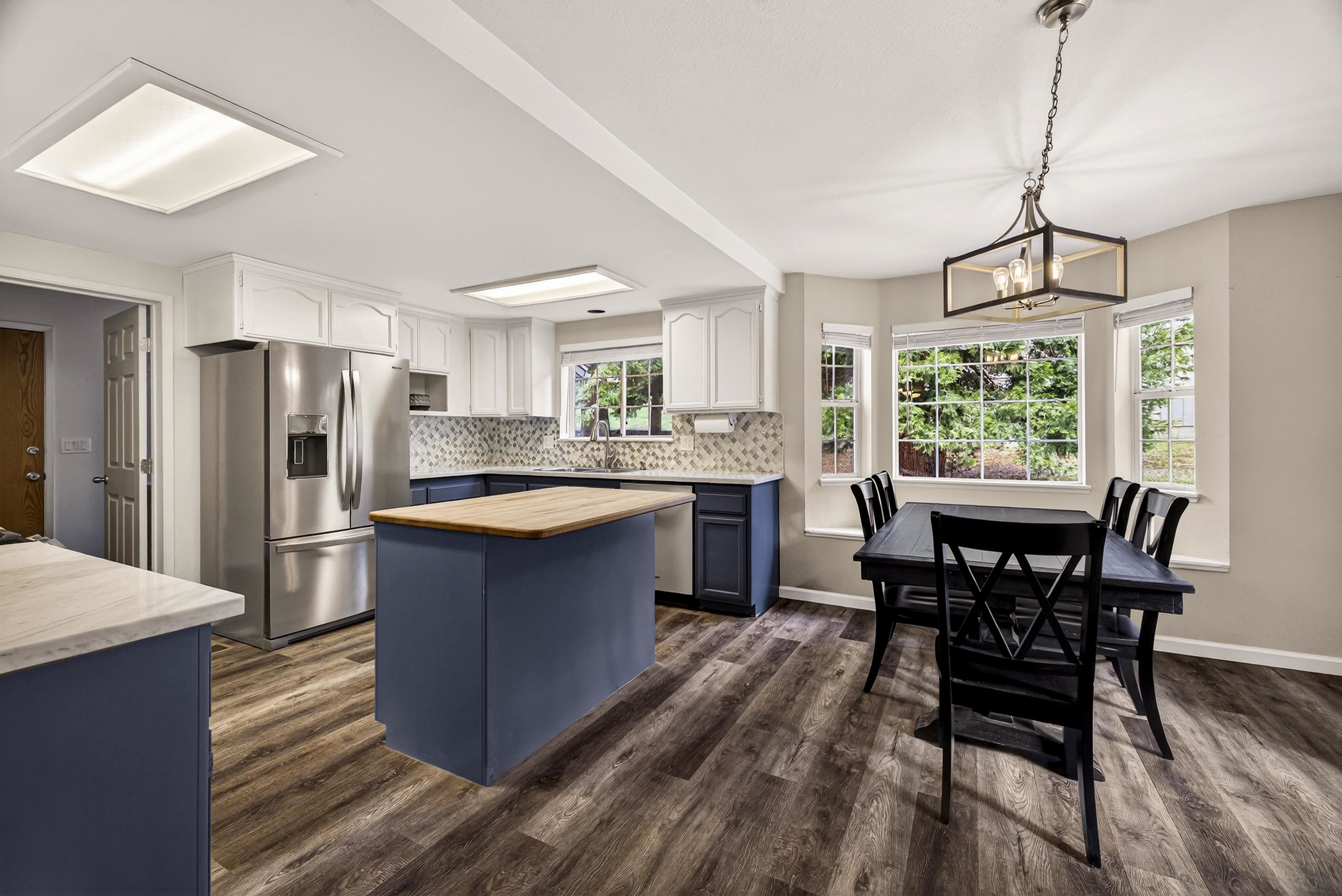 811 Golf Club Road Lake Almanor, CA 96137 - Photo 14 of 42 a kitchen with a table chairs refrigerator and cabinets