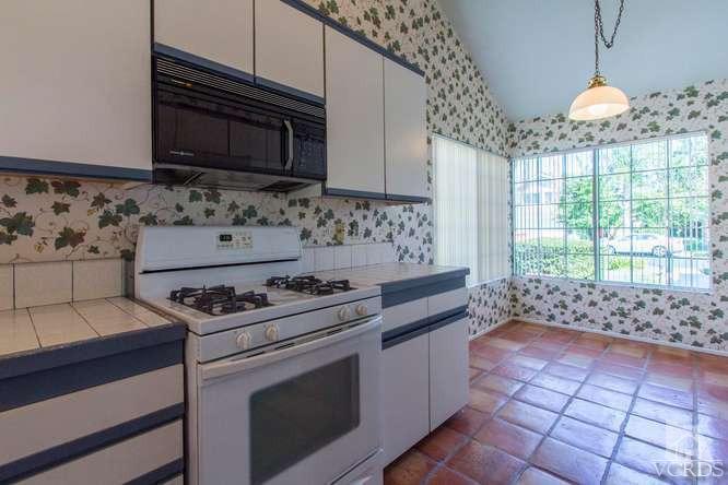 529 Fairfield Road Simi Valley, CA 93065 - Photo 8 of 21 a kitchen with stainless steel appliances a stove a sink and a microwave