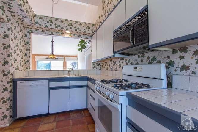 529 Fairfield Road Simi Valley, CA 93065 - Photo 9 of 21 a kitchen with stainless steel appliances granite countertop a stove a sink and a microwave
