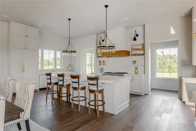 a view of a dining room with furniture large windows and wooden floor