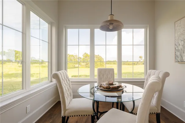 a view of a walk in closet with wooden floor