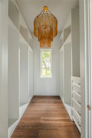 a view of walk in closet with empty racks